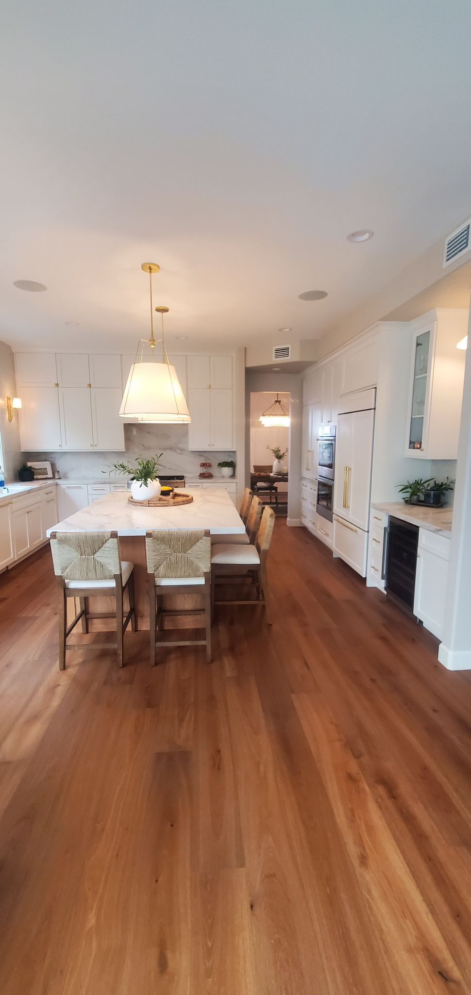 Custom kitchen cabinet installation in San Diego — two-tone with integrated appliances and quartz countertops