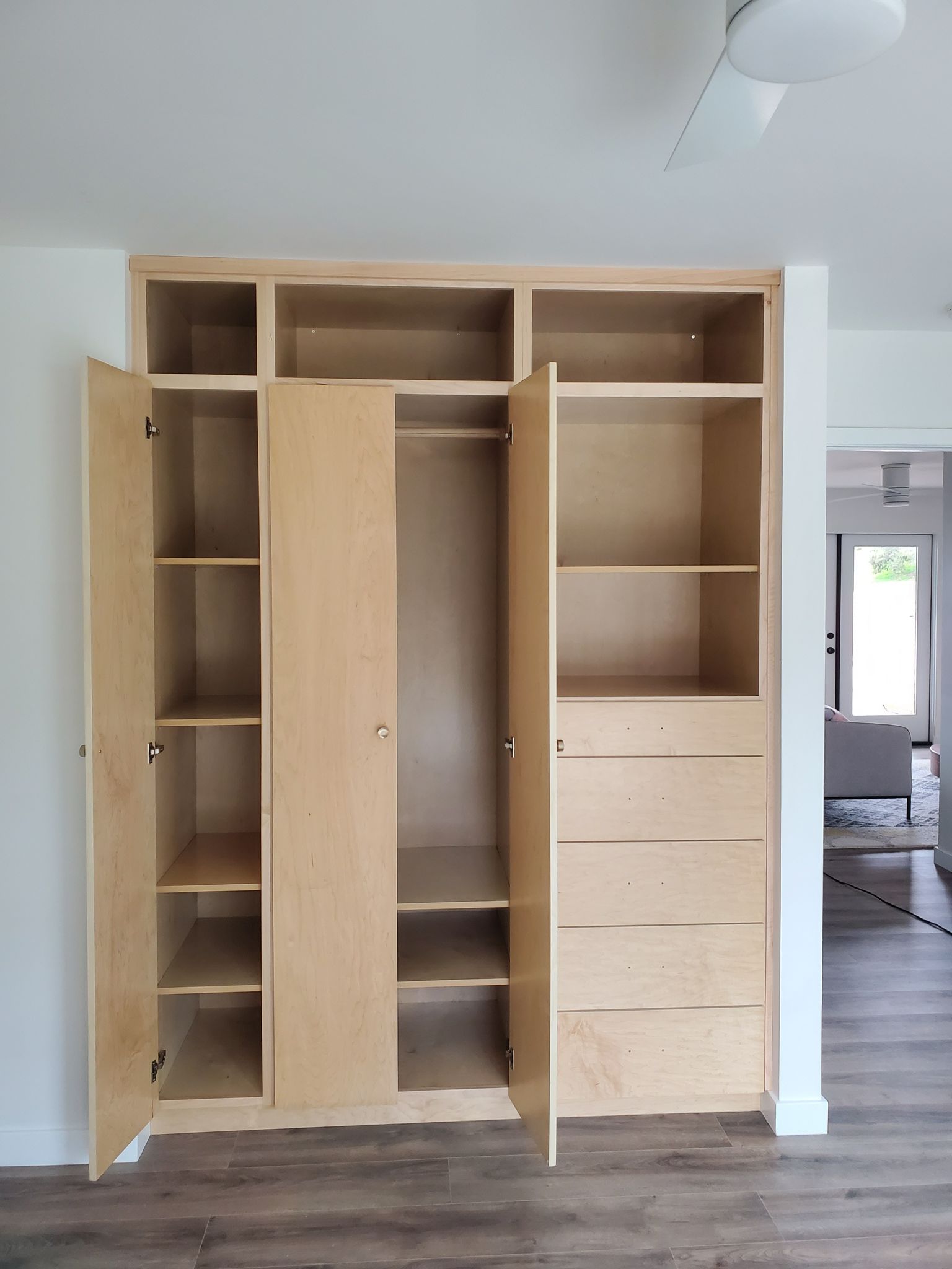 Professionally refinished kitchen cabinets in San Diego — smooth factory-quality spray finish in warm white
