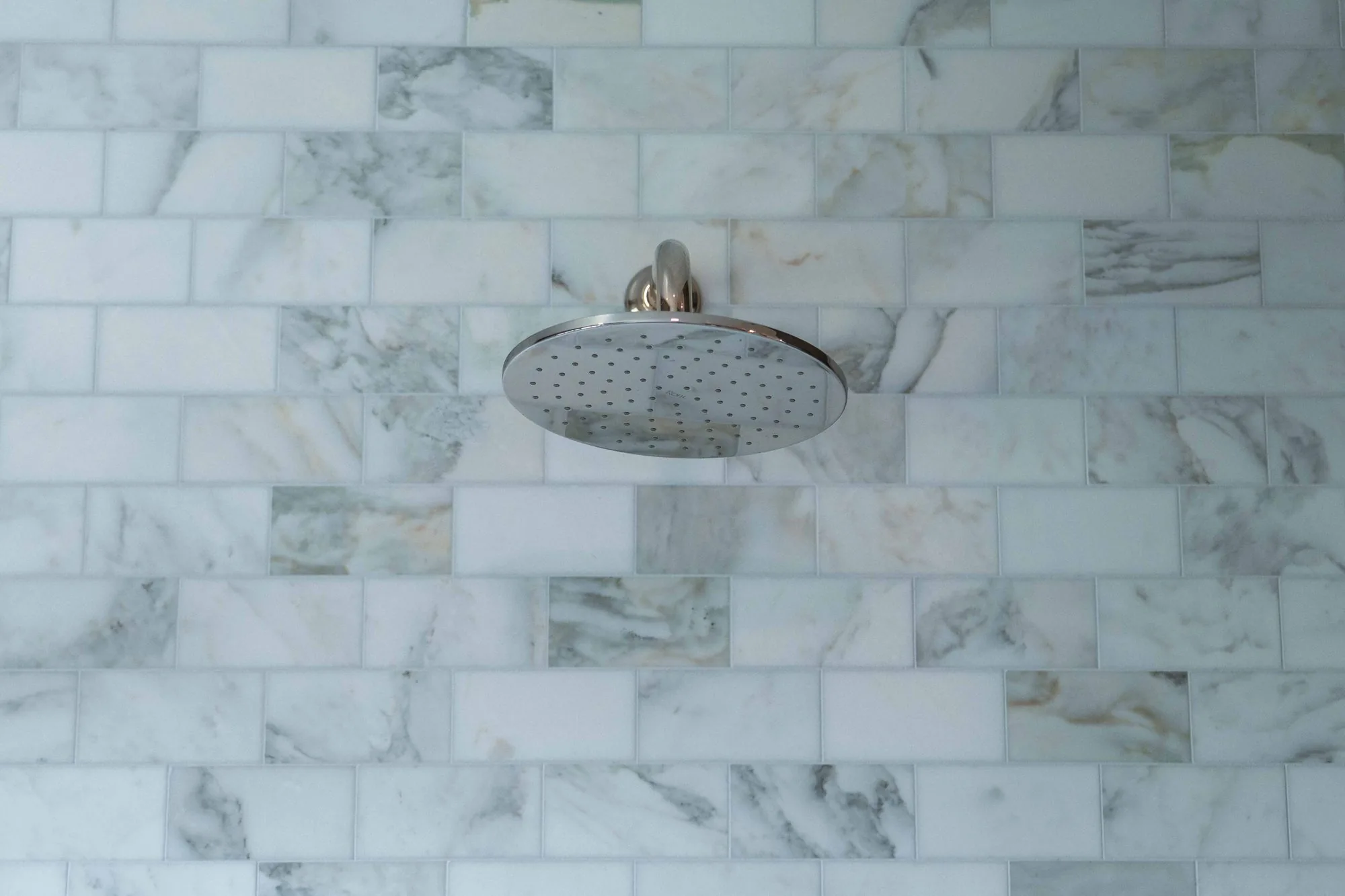 Ultra-luxury primary bathroom remodel in Rancho Santa Fe CA with dual floating white oak vanities, freestanding soaking tub, and Calacatta marble tile — SD Remodel Experts