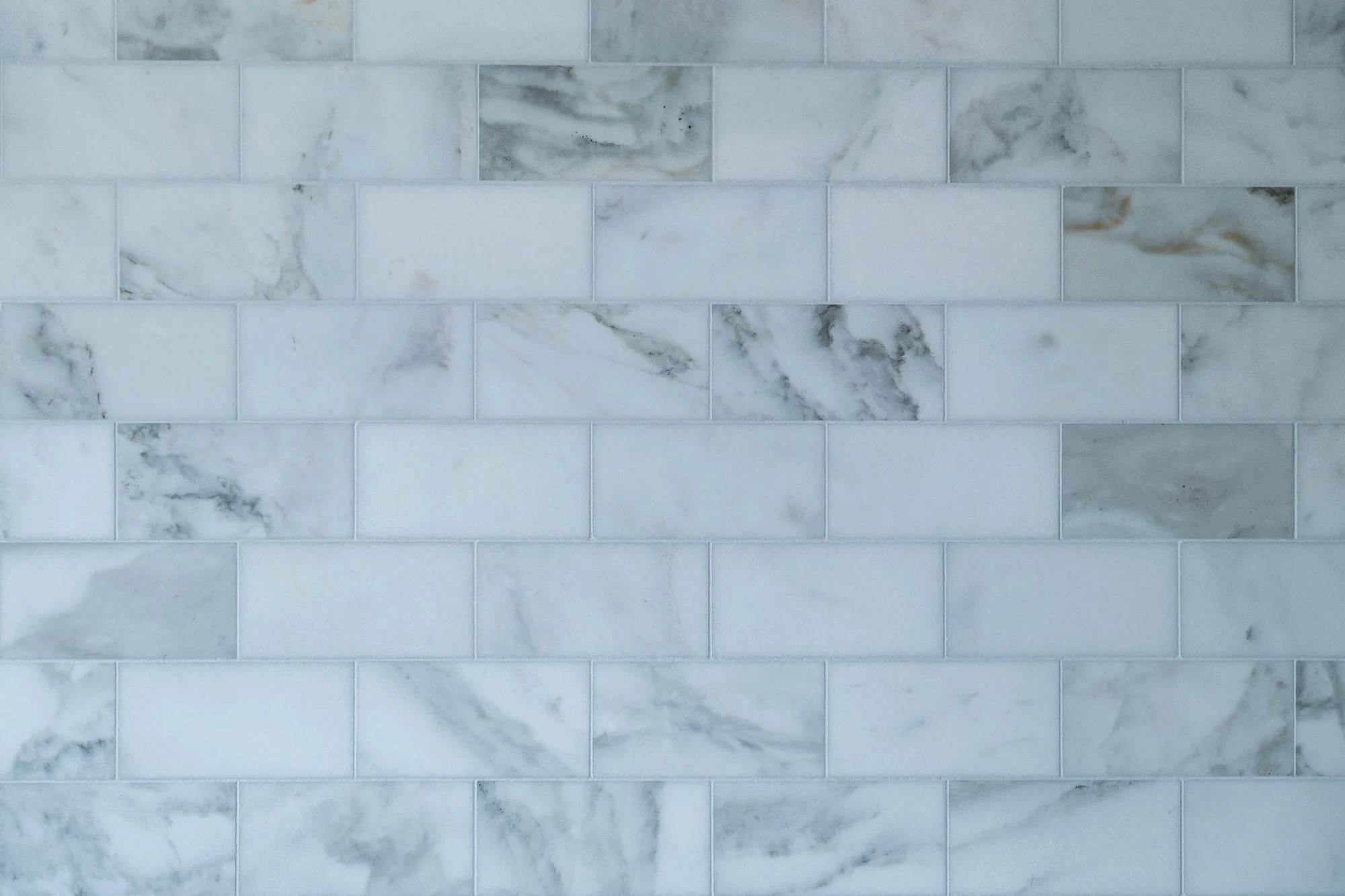 Luxury spa bathroom remodel in Rancho Santa Fe estate with freestanding soaking tub, bespoke dual vanity, walk-in steam shower, and book-matched marble tile — SD Remodel Experts