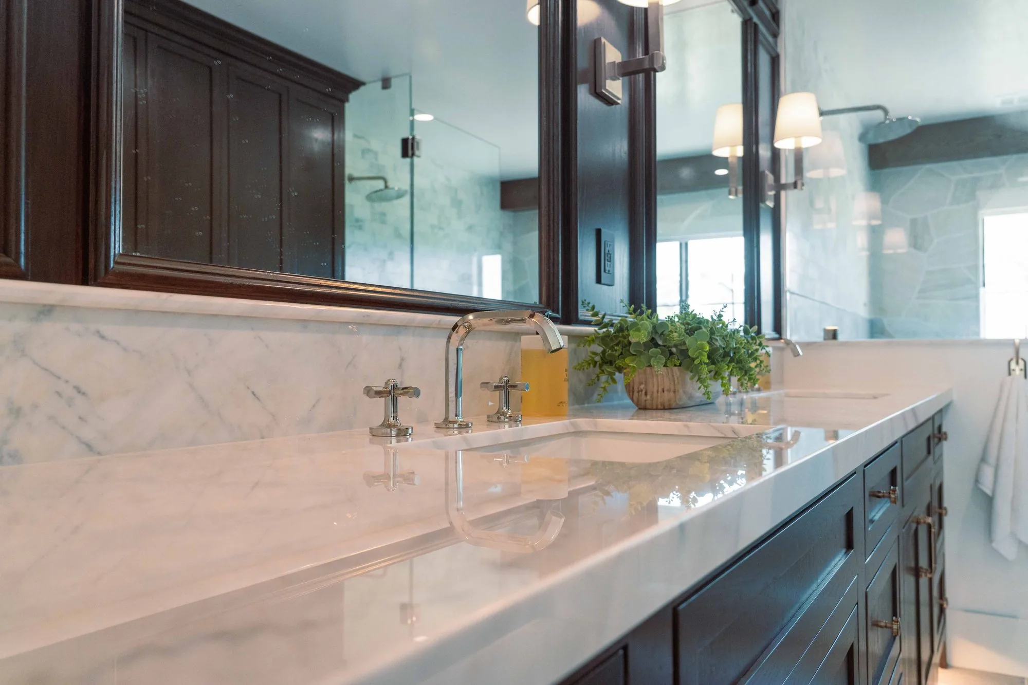 Spa-style master bathroom in La Jolla with soaking tub, custom wood vanity, and floor-to-ceiling tile by SD Remodel Experts